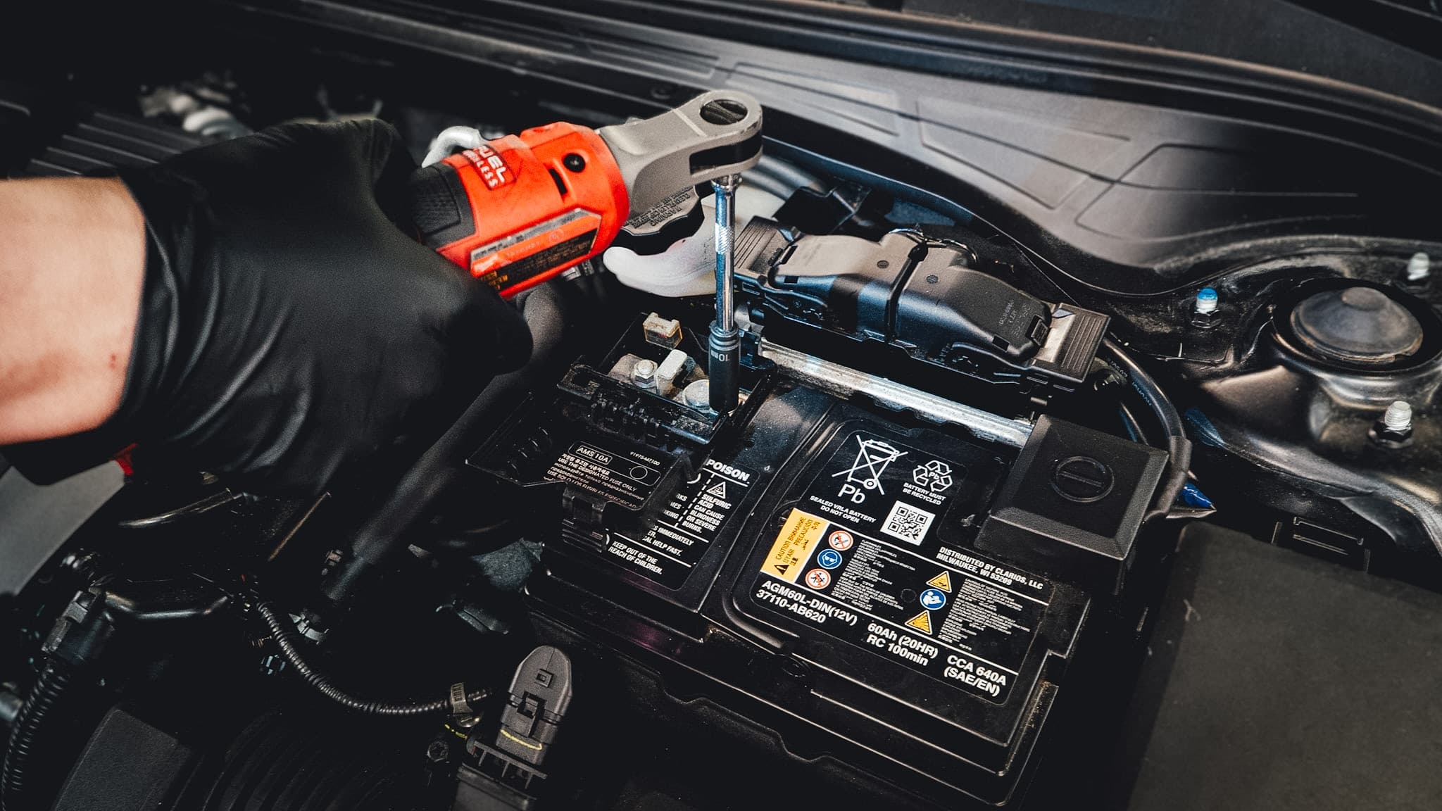 Technician working on a wheel and tire assembly in the repair bay